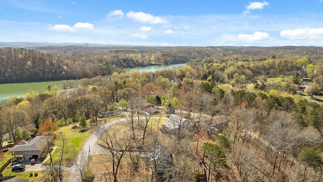 aerial view featuring a wooded view and a water view