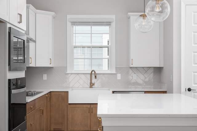 kitchen with white cabinetry, light countertops, decorative backsplash, and black appliances
