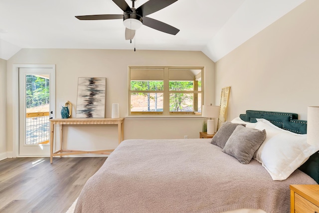 bedroom featuring vaulted ceiling, a ceiling fan, wood finished floors, and access to outside