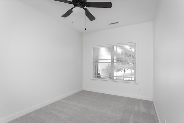 unfurnished room featuring a ceiling fan, light carpet, baseboards, and visible vents