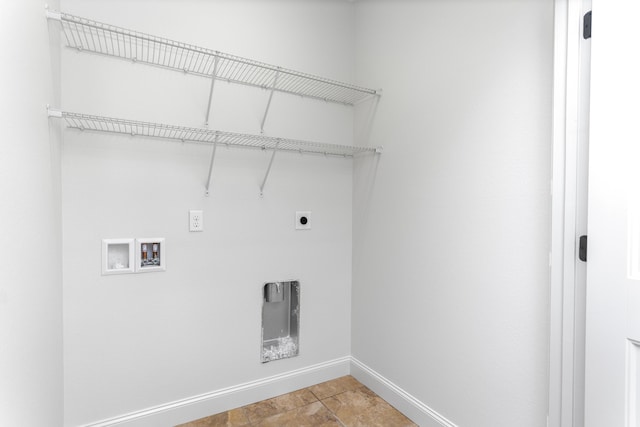 clothes washing area with baseboards, hookup for an electric dryer, laundry area, and hookup for a washing machine