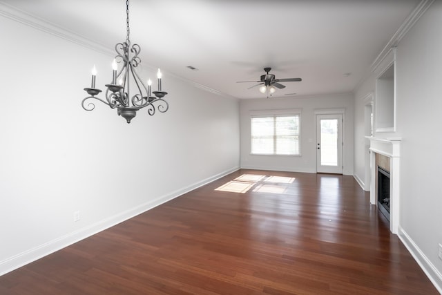 unfurnished living room with ornamental molding, ceiling fan with notable chandelier, a fireplace, and dark wood-type flooring