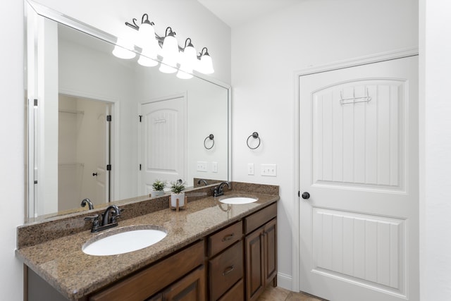 full bathroom featuring double vanity and a sink