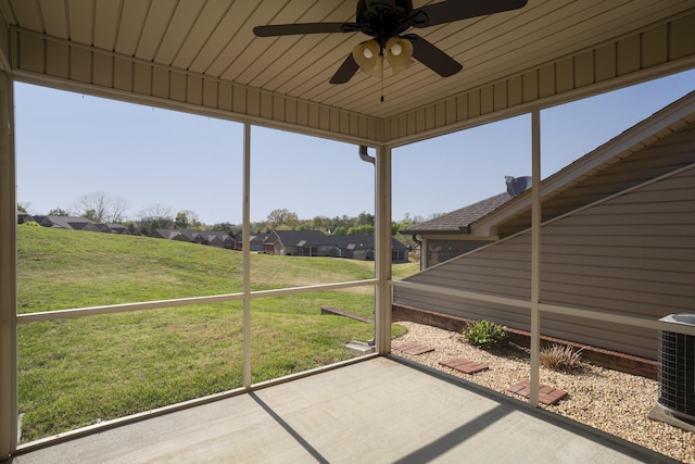 unfurnished sunroom with plenty of natural light and ceiling fan