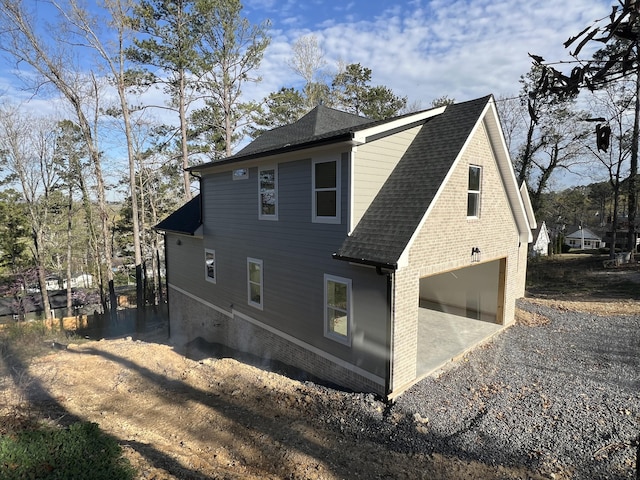 581 Benson Dr, Chattanooga, TN 37412 - view of home's exterior with brick siding, a shingled roof, and a garage