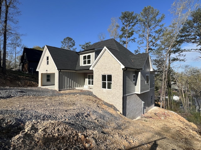 581 Benson Dr, Chattanooga, TN 37412 - view of front of house with brick siding, roof with shingles, and board and batten siding