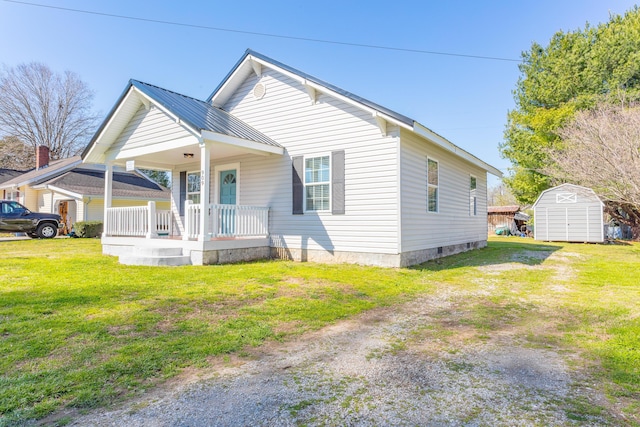 909 Stewart Ave, Chickamauga, GA 30707 - view of front of home with an outbuilding, a shed, metal roof, a front yard, and a porch