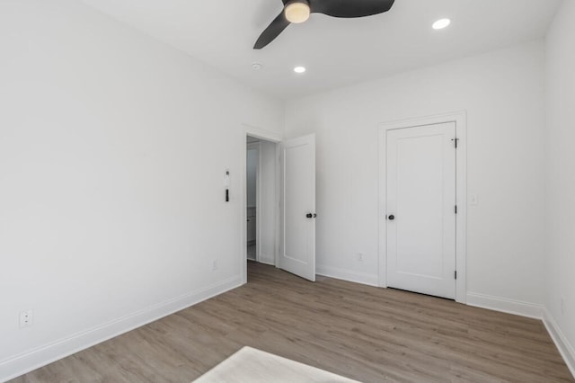 unfurnished bedroom with baseboards, wood finished floors, recessed lighting, and a ceiling fan