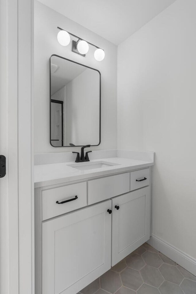 bathroom with tile patterned floors, vanity, and baseboards
