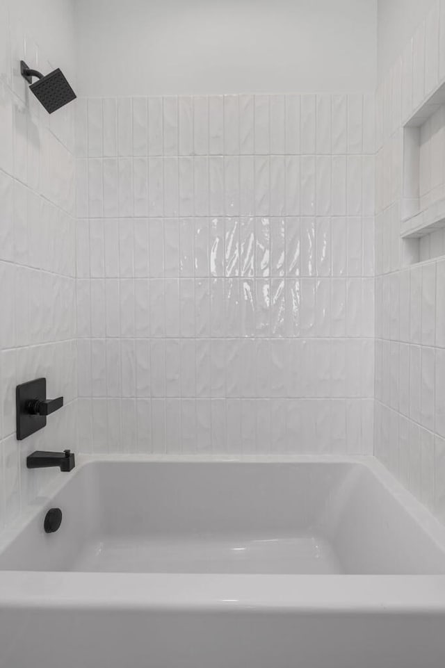 bathroom with a bath and a shower
