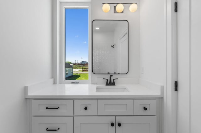 full bath featuring walk in shower and vanity