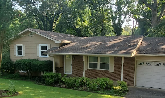 1603 Lisa Lynn Dr, Hixson, TN 37343 - view of front of property featuring an attached garage, brick siding, a shingled roof, and a front yard