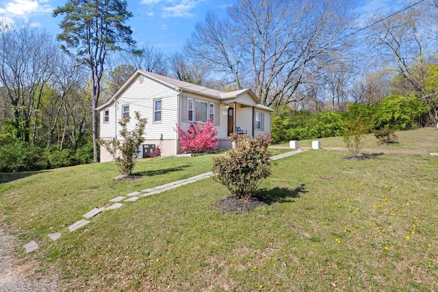 view of property exterior with central air condition unit, a lawn, and a garage
