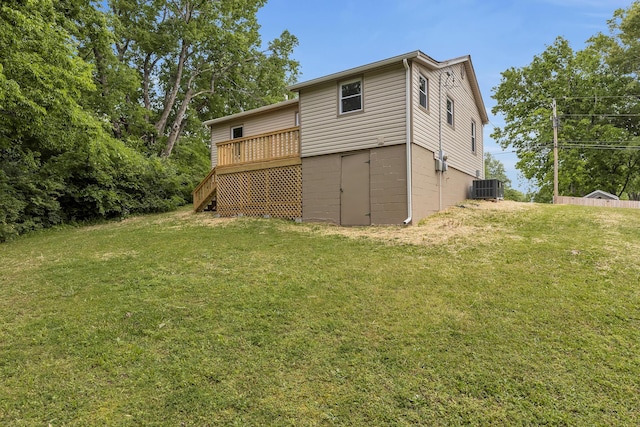 rear view of property with stairs, a deck, central AC, and a lawn