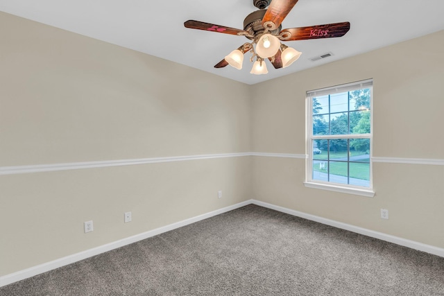unfurnished room with visible vents, carpet, baseboards, and ceiling fan
