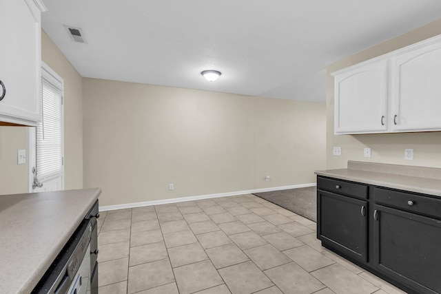 kitchen with visible vents, light countertops, baseboards, dark cabinetry, and white cabinetry