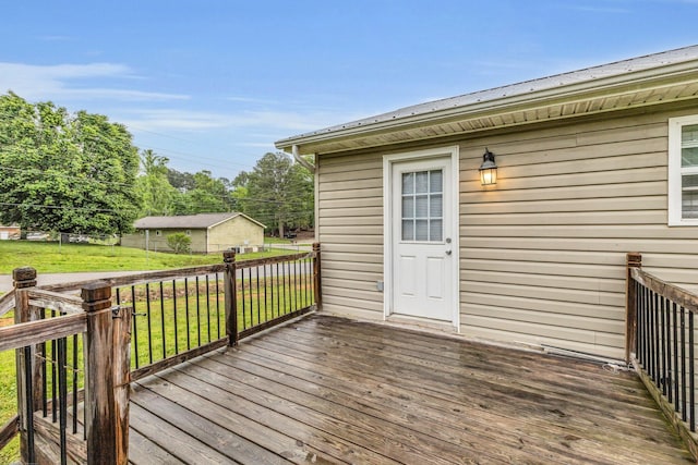 deck with a lawn and an outdoor structure