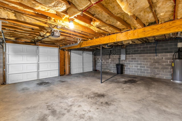 garage with gas water heater, a garage door opener, and electric panel
