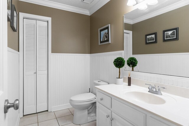 9215 Smokewood Trl, Chattanooga, TN 37421 - bathroom featuring a closet, vanity, wainscoting, crown molding, and tile patterned floors
