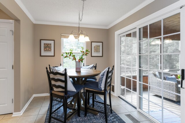 9215 Smokewood Trl, Chattanooga, TN 37421 - dining room with light tile patterned flooring, a chandelier, crown molding, and a textured ceiling
