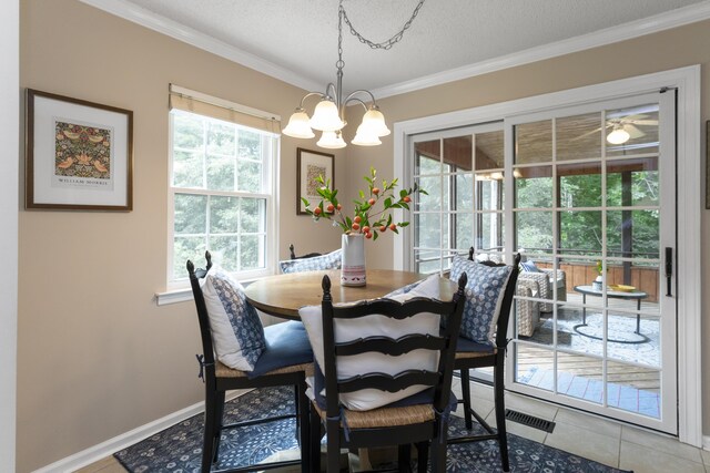 9215 Smokewood Trl, Chattanooga, TN 37421 - dining room with a chandelier, ornamental molding, a textured ceiling, and light tile patterned flooring