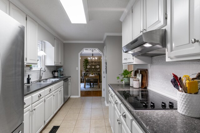 9215 Smokewood Trl, Chattanooga, TN 37421 - kitchen featuring appliances with stainless steel finishes, under cabinet range hood, dark countertops, decorative backsplash, and ornamental molding
