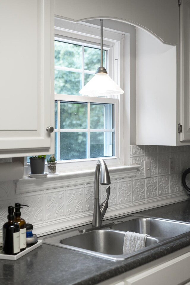 9215 Smokewood Trl, Chattanooga, TN 37421 - kitchen with dark countertops, backsplash, white cabinetry, and healthy amount of natural light