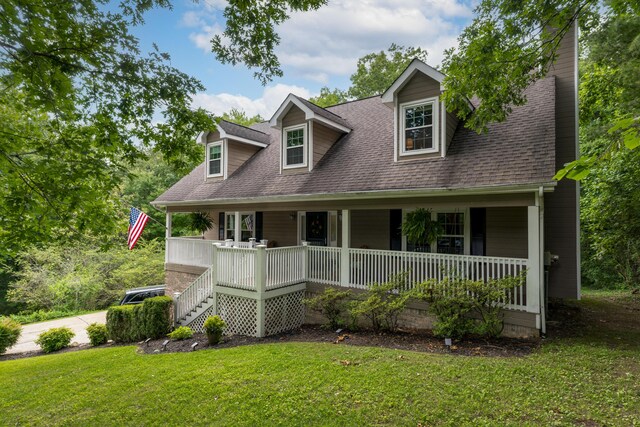 9215 Smokewood Trl, Chattanooga, TN 37421 - cape cod home with covered porch, a front lawn, a shingled roof, and a chimney