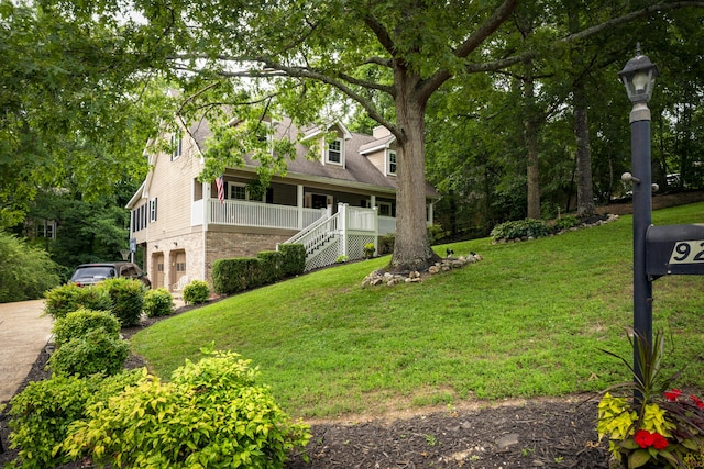 9215 Smokewood Trl, Chattanooga, TN 37421 - view of green lawn with covered porch, stairs, driveway, and an attached garage