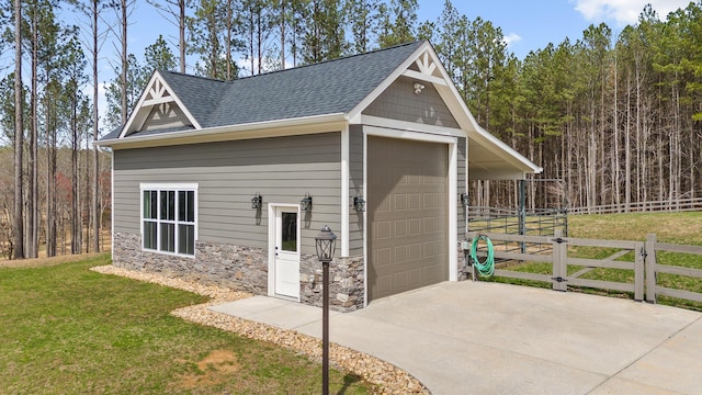 garage with driveway and fence