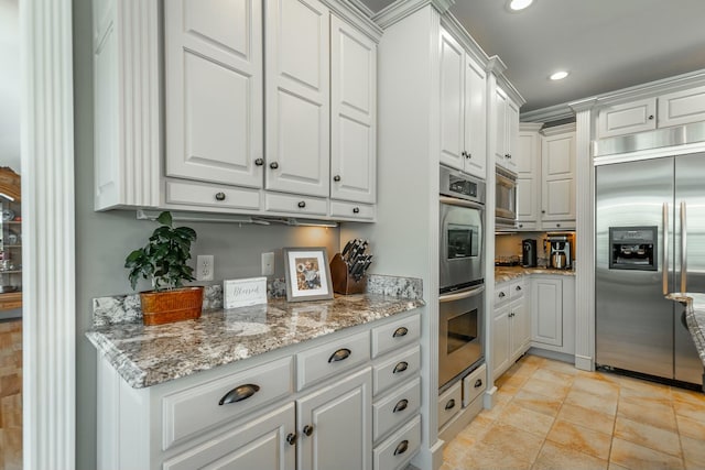 kitchen with light tile patterned floors, white cabinets, recessed lighting, and stainless steel appliances