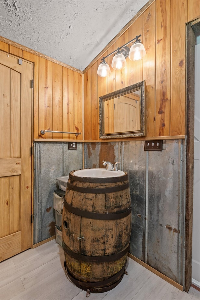 bathroom with vanity, a textured ceiling, and wood finished floors