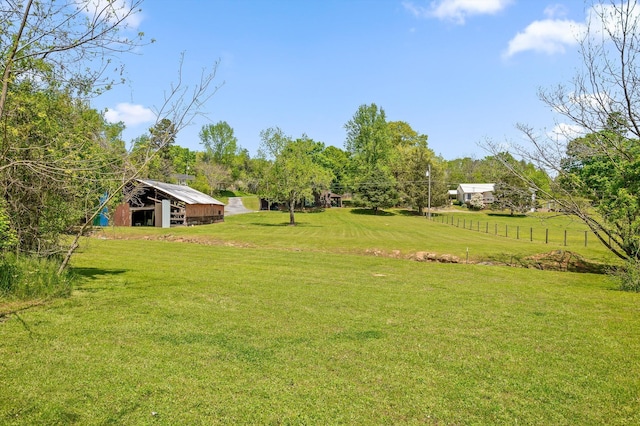 view of yard featuring an outdoor structure and an outbuilding