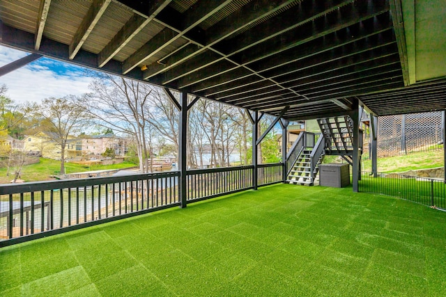 view of yard featuring stairway and fence