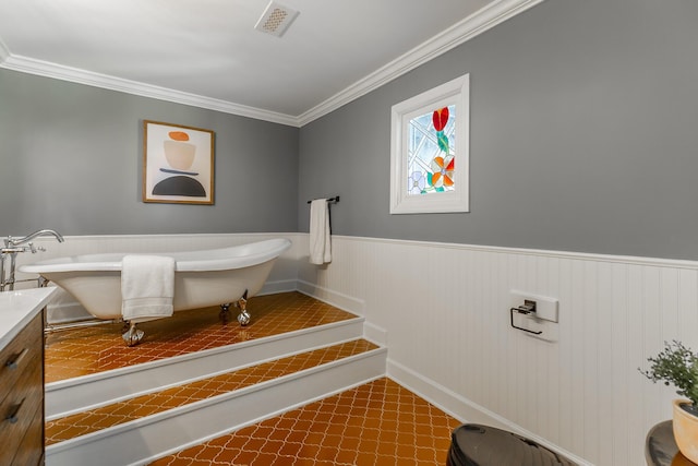 bathroom featuring a wainscoted wall, visible vents, ornamental molding, vanity, and a freestanding bath
