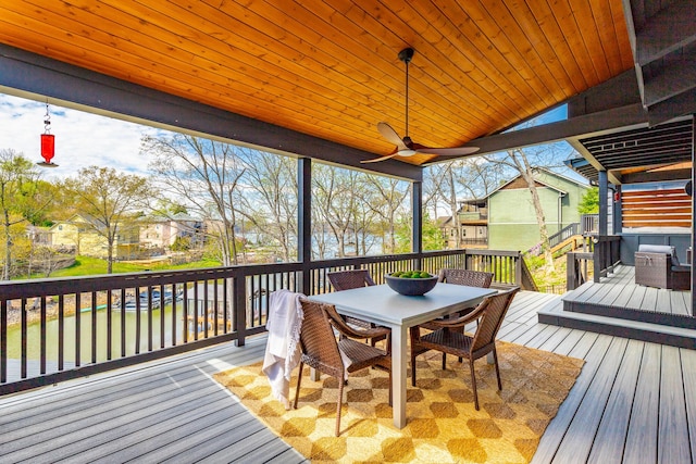 wooden terrace featuring outdoor dining area and a ceiling fan