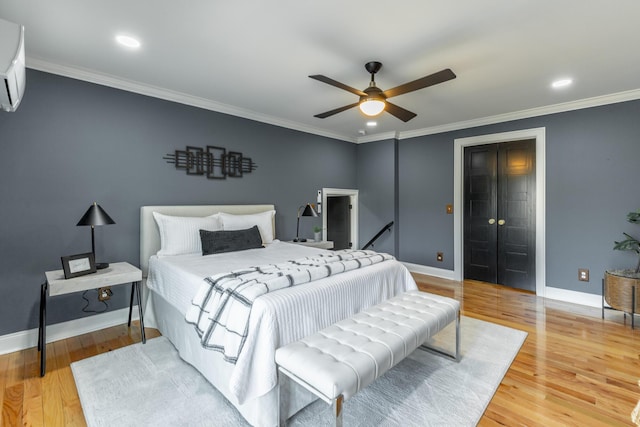 bedroom with baseboards, crown molding, wood finished floors, and recessed lighting