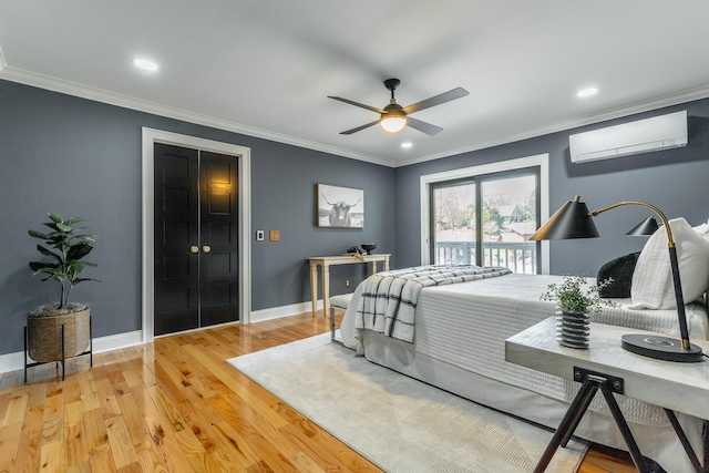 bedroom with access to exterior, a wall unit AC, light wood-type flooring, and ornamental molding