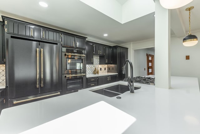 kitchen featuring light countertops, ornamental molding, high end fridge, a sink, and backsplash