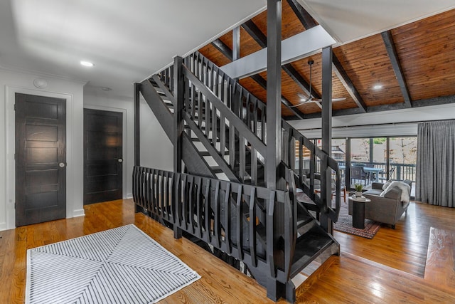 stairway featuring wood-type flooring, wooden ceiling, beam ceiling, and recessed lighting