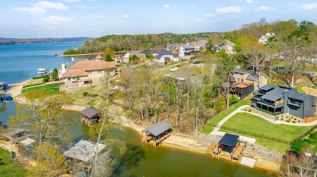 drone / aerial view featuring a residential view and a water view