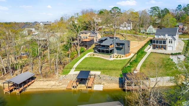 birds eye view of property with a water view and a residential view