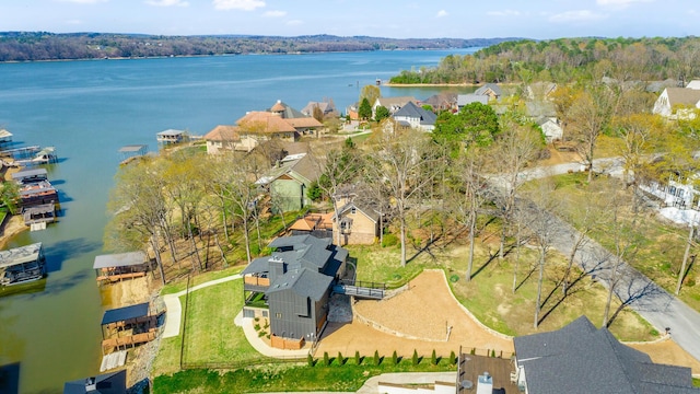 drone / aerial view featuring a water view and a residential view