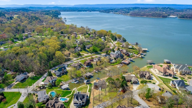 aerial view with a water view, a wooded view, and a residential view