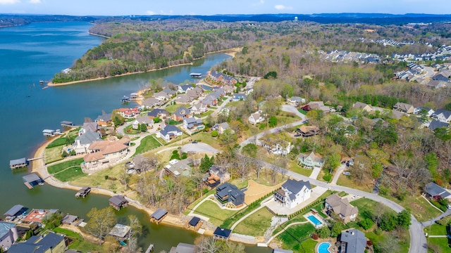 bird's eye view with a residential view, a water view, and a wooded view