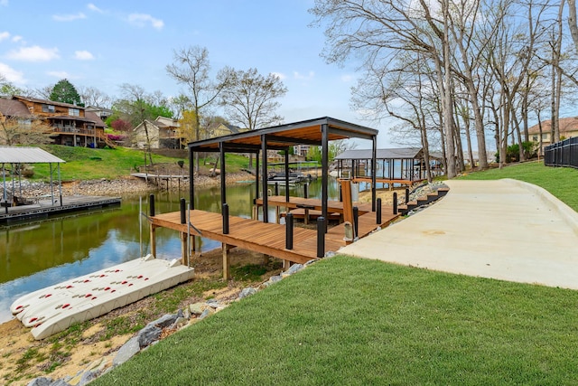 dock area with a water view and a yard