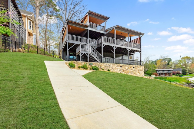 back of property featuring fence and a yard