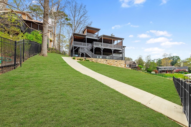 view of yard featuring a fenced backyard and stairway