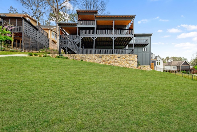rear view of property with fence and a yard