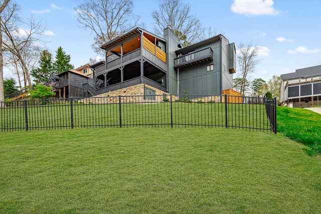 rear view of property with a lawn and fence